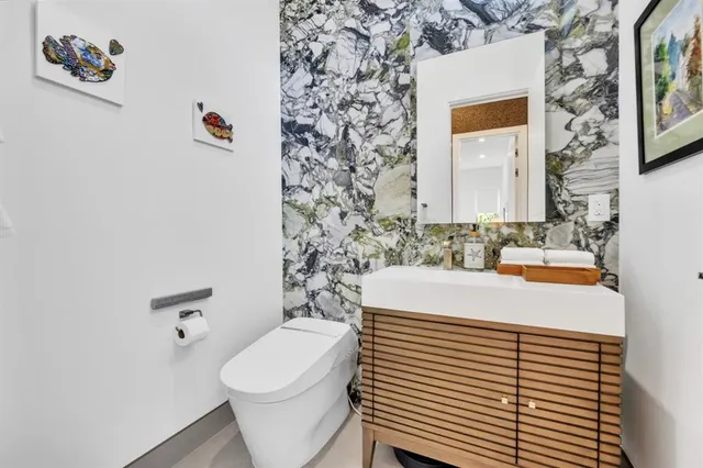 a bathroom with a double vanity sink a mirror and a bathtub
