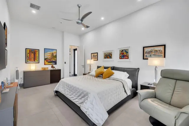 a bedroom with a bed and a flat screen television