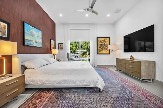 a view of a patio with table and chairs potted plants and large tree
