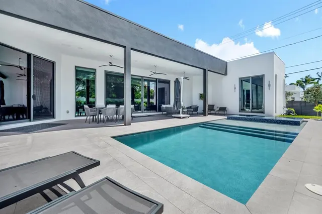 a view of a patio with a dining table and chairs