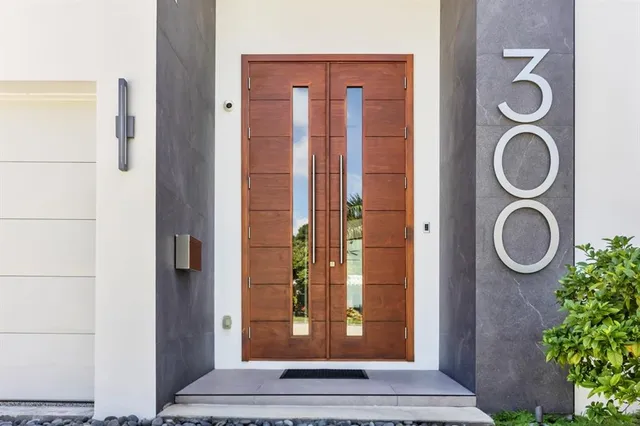 a bedroom with furniture and a large window