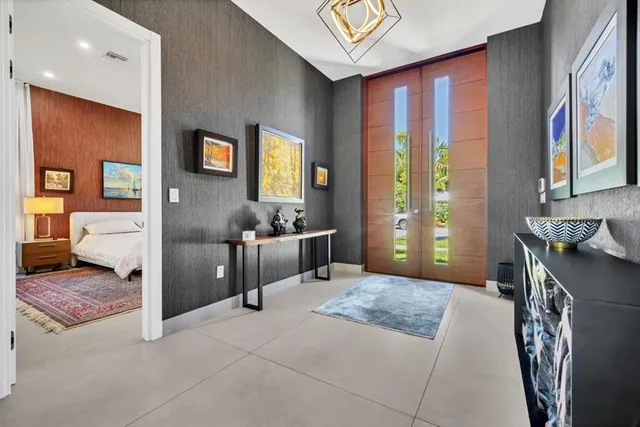 a living room with furniture and painting on the wall