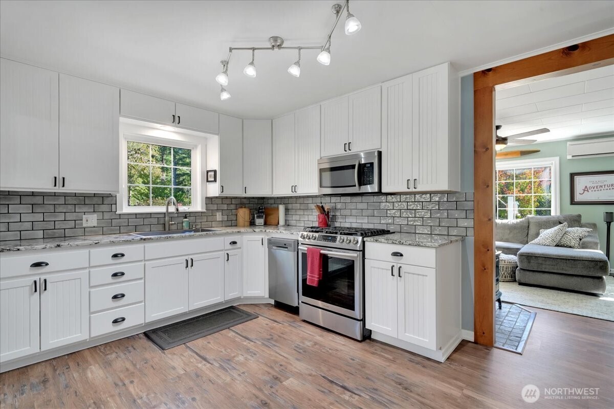 269 Logan Hill Road Chehalis, WA 98532 - Photo 3 of 40 a kitchen with stainless steel appliances granite countertop a stove and white cabinets