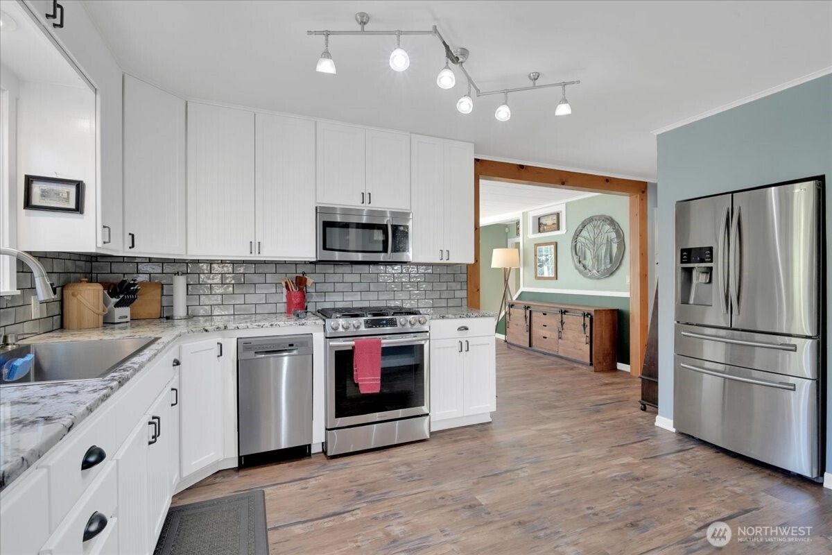 269 Logan Hill Road Chehalis, WA 98532 - Photo 5 of 40 a kitchen with stainless steel appliances granite countertop a stove top oven a sink and a refrigerator