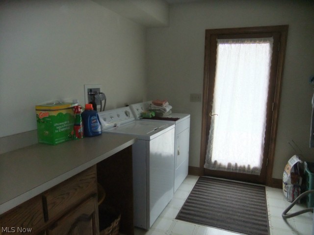 7405 State Road Wadsworth, OH 44281 - Photo 19 of 25 Laundry room with counter top perfect for folding and placing your personals. The doorway is leading out to the back wooden deck, and lets in a lot of natural light into the room.
