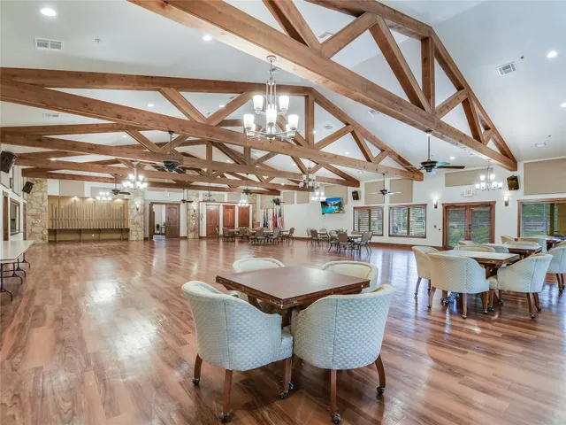 a large kitchen with kitchen island a large counter top stainless steel appliances and cabinets