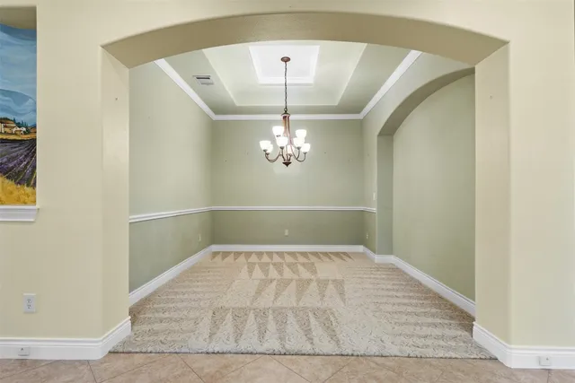 an empty room with windows and cabinet