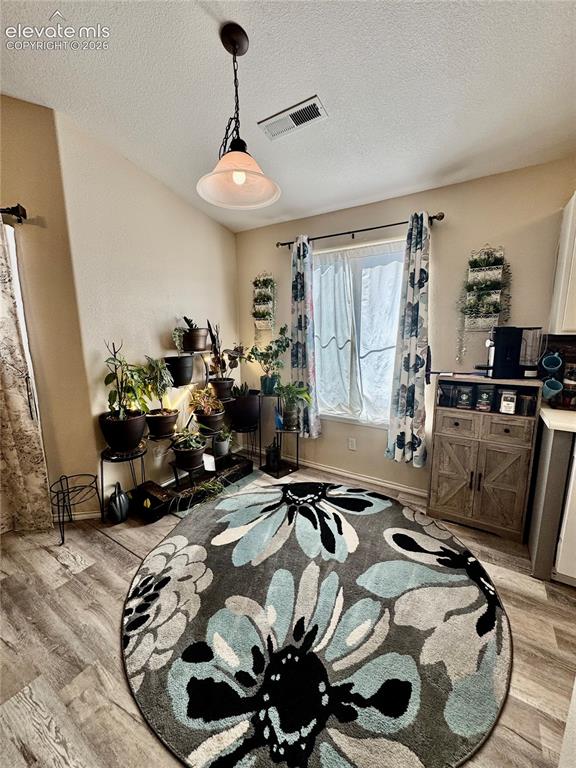 3748 Riviera Grove, Unit 203 Colorado Springs, CO 80922 - Photo 9 of 23 a room with furniture and a chandelier