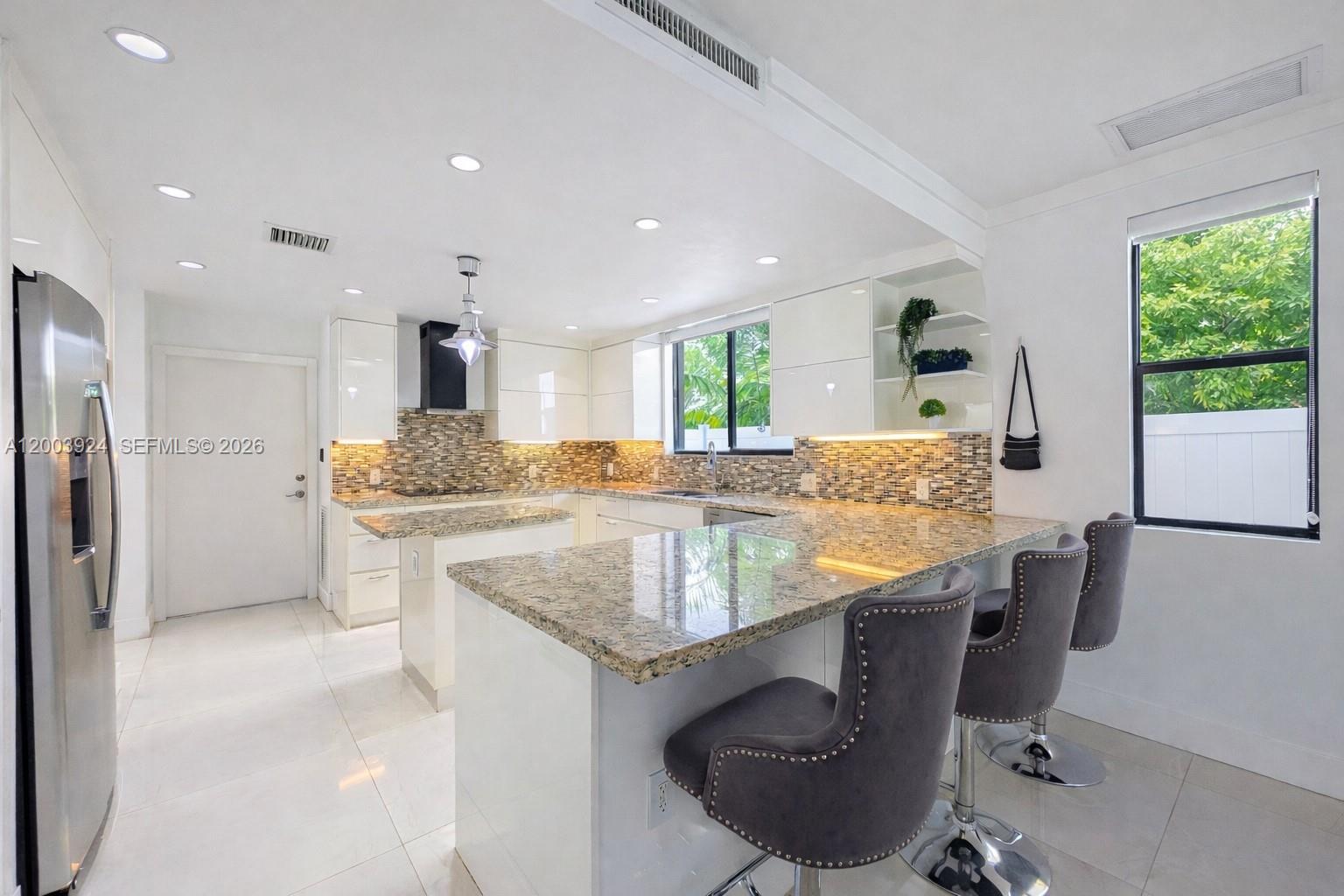 471 Southwest 30th Road Miami, FL 33129 - Photo 10 of 39 a kitchen with stainless steel appliances granite countertop a sink stove and refrigerator