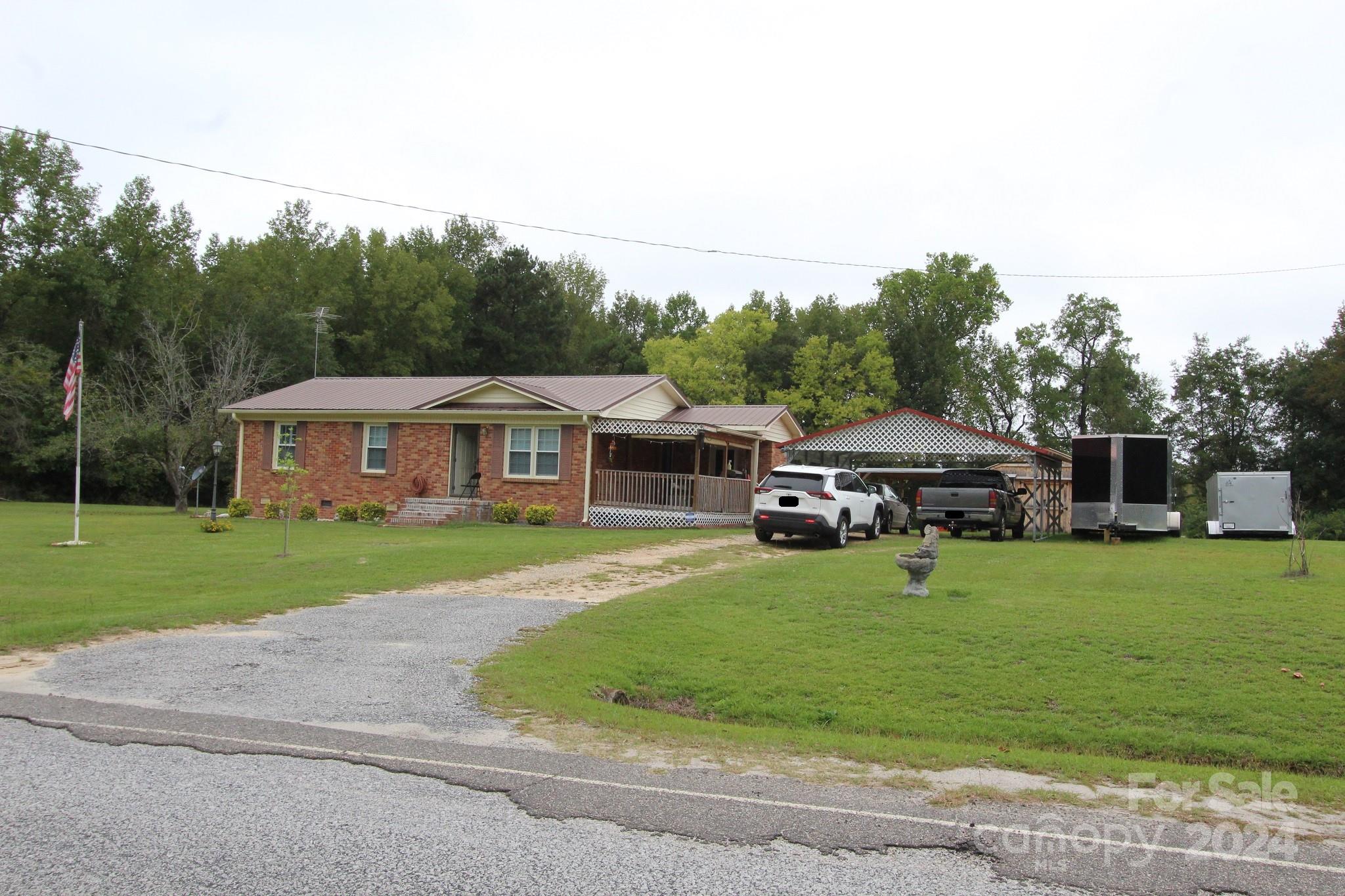 188 Land Of Promise Road Chesterfield, SC 29709 - Photo 3 of 27 a front view of a house with a garden and trees