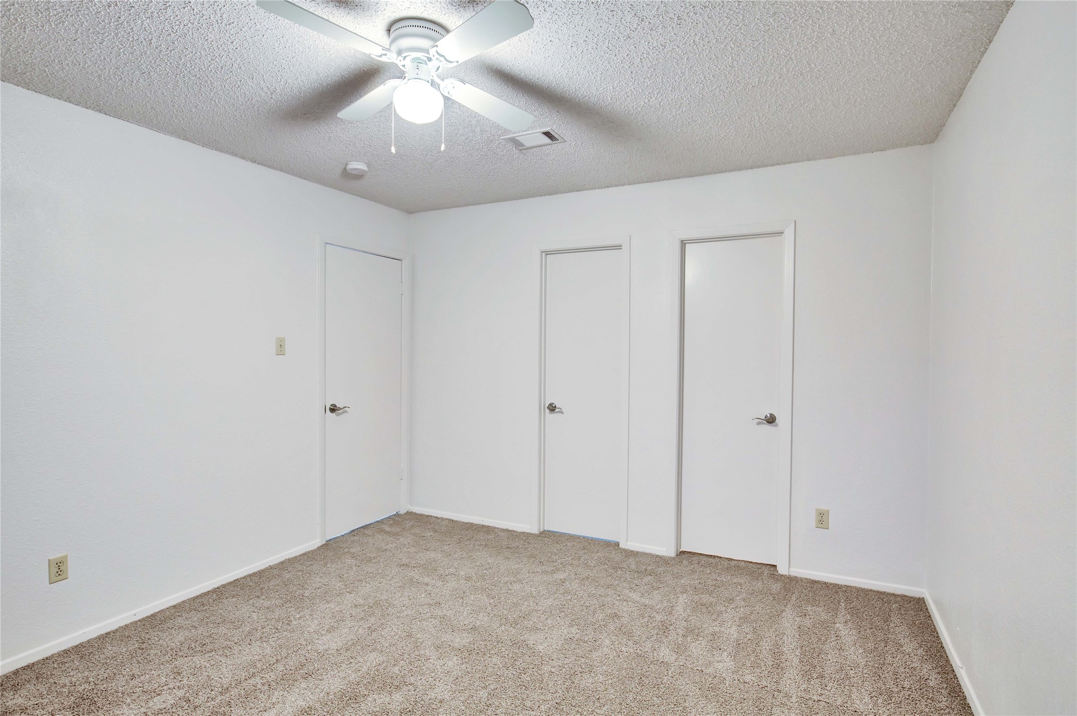 2807 Firecrest Drive Austin, TX 78748 - Photo 12 of 30 Carpeted room featuring a ceiling fan with light, white walls, and multiple white doors