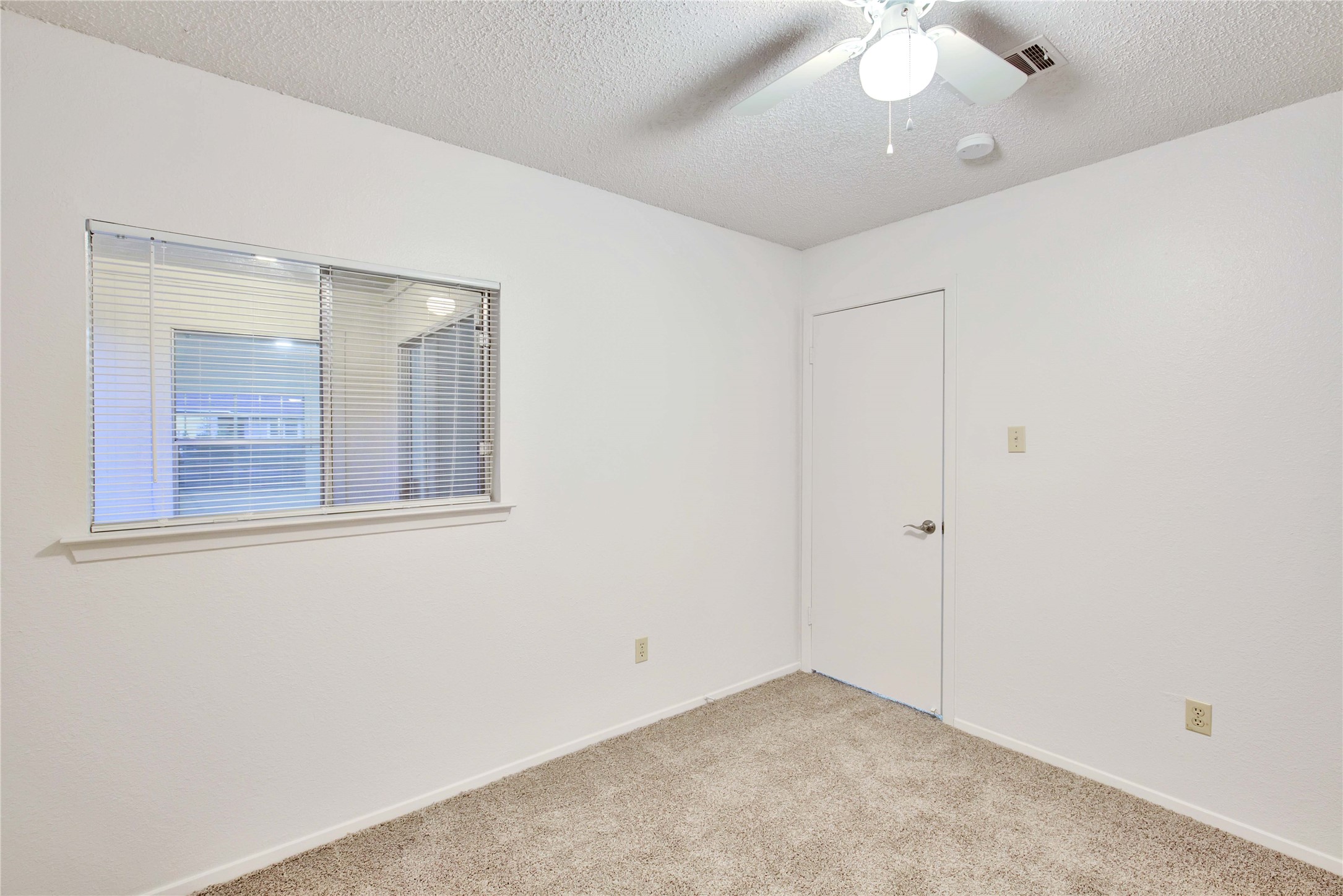 2807 Firecrest Drive Austin, TX 78748 - Photo 16 of 30 Carpeted room with a ceiling fan, a window fitted with blinds, and a white interior door
