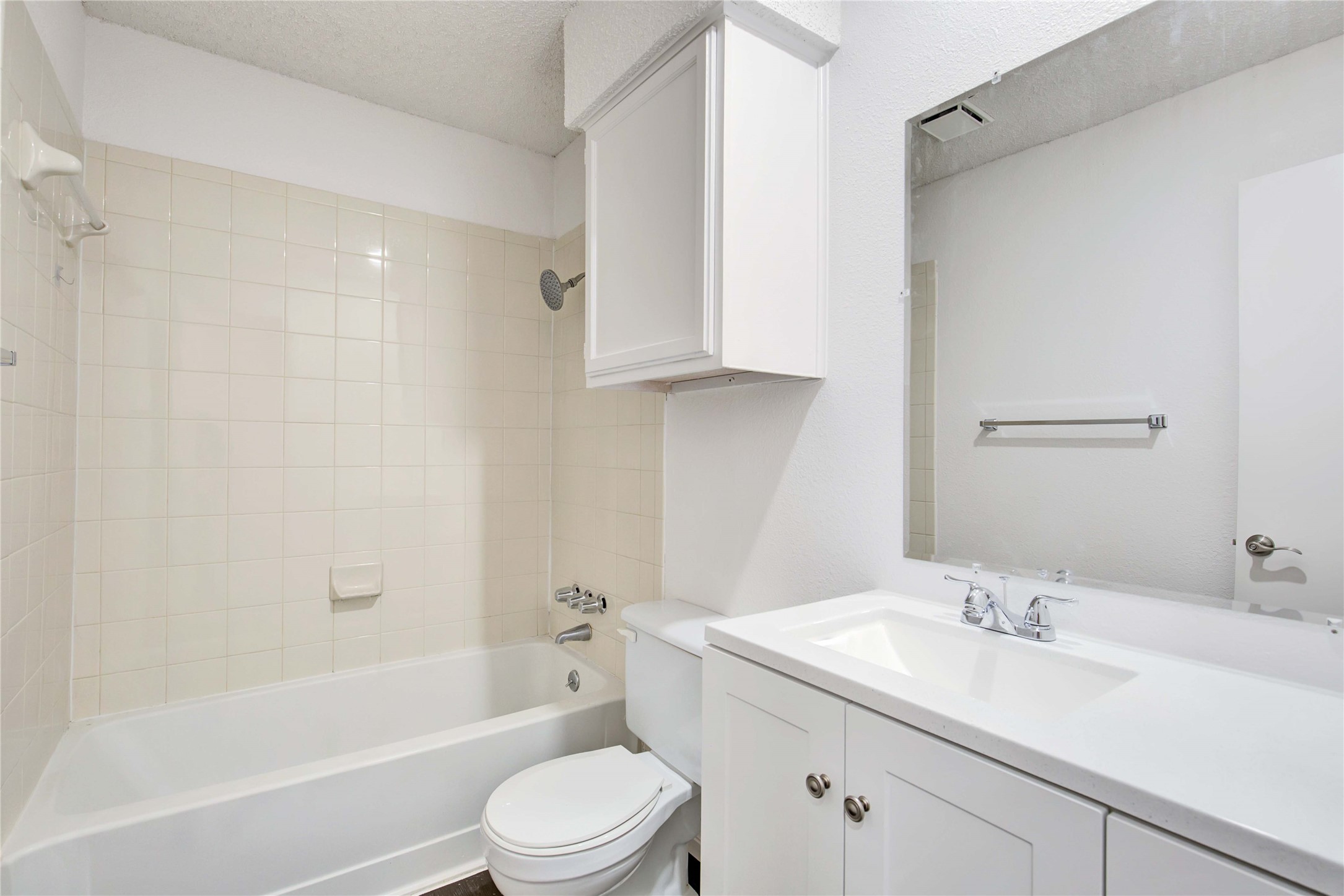 2807 Firecrest Drive Austin, TX 78748 - Photo 21 of 30 White-tiled bath and shower combination with chrome fixtures