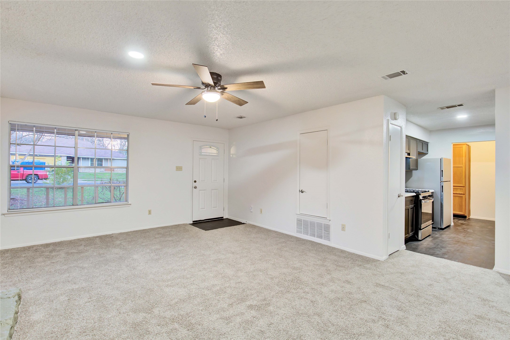 2807 Firecrest Drive Austin, TX 78748 - Photo 22 of 30 Expansive living area featuring light-toned carpeting, a ceiling fan with integrated lighting, and recessed ceiling lights
