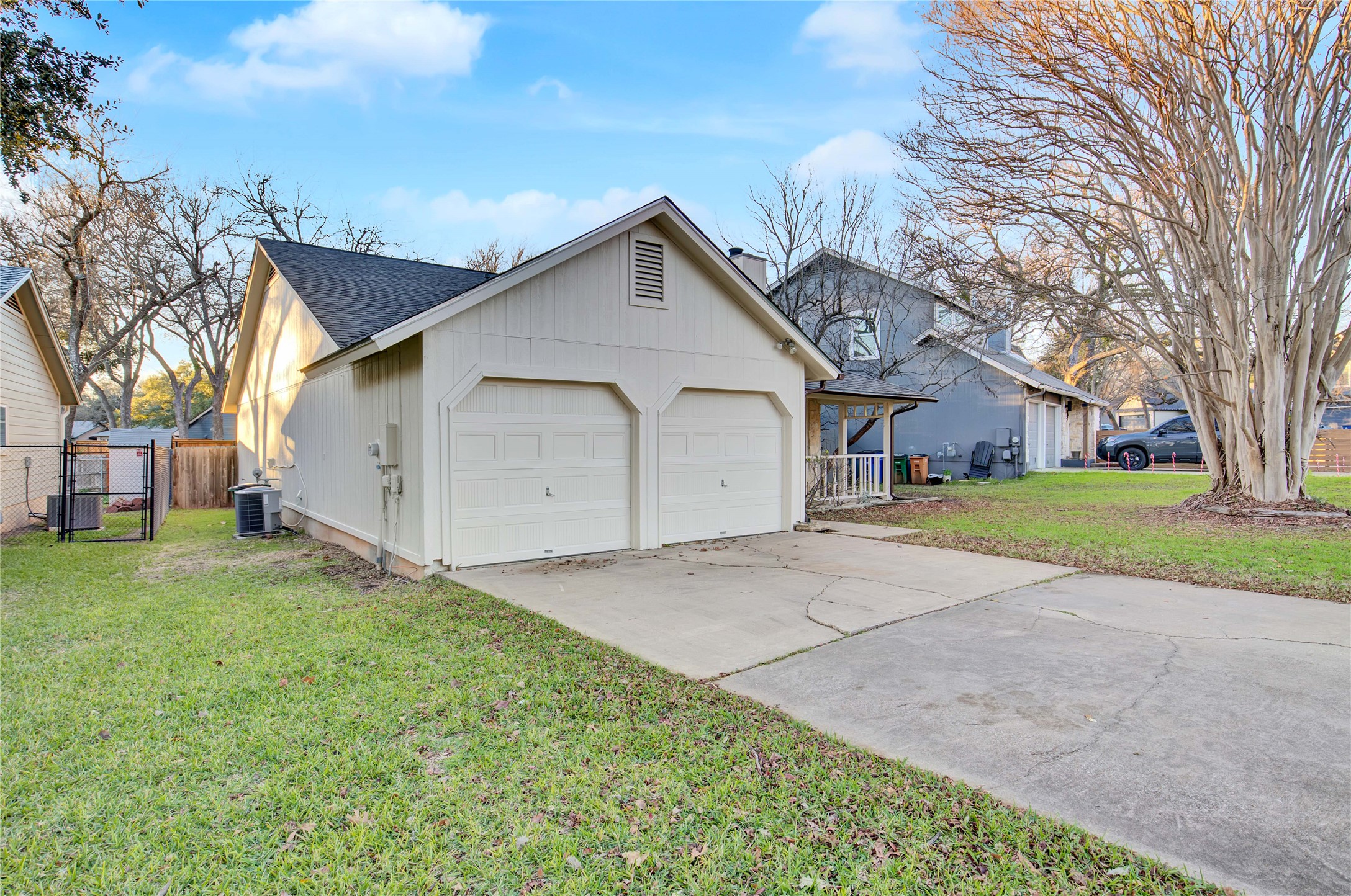 2807 Firecrest Drive Austin, TX 78748 - Photo 23 of 30 Two-car garage with white paneled doors and a gabled roofline