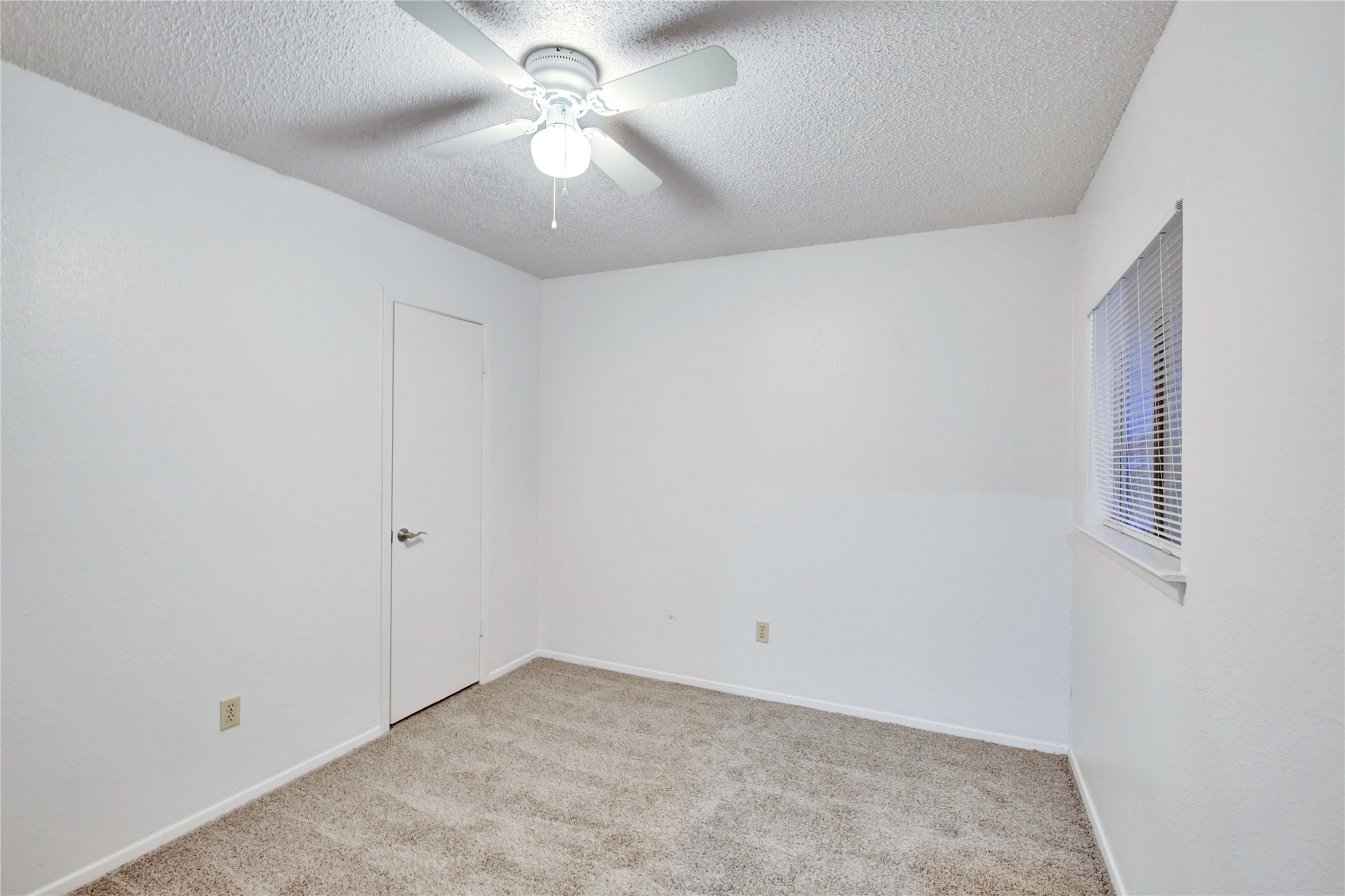 2807 Firecrest Drive Austin, TX 78748 - Photo 25 of 30 Carpeted room with white walls, a single window with blinds, and a ceiling fan with integrated lighting