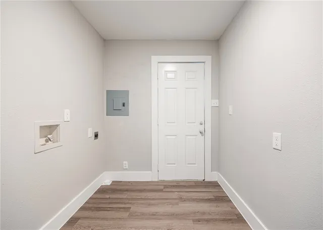 a view of an empty room with window and closet area