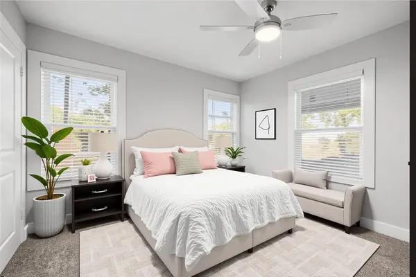 a bedroom with furniture and a potted plant
