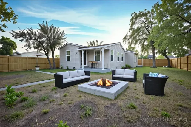 a view of a house with backyard and sitting area