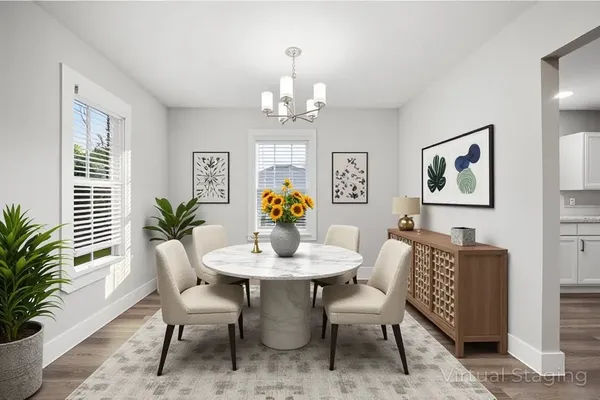 a view of a dining room with furniture and chandelier