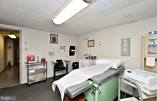 a room with a table chairs and white walls