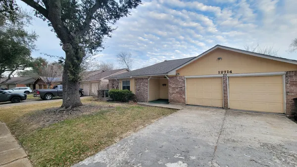 a view of a house with a yard and garage