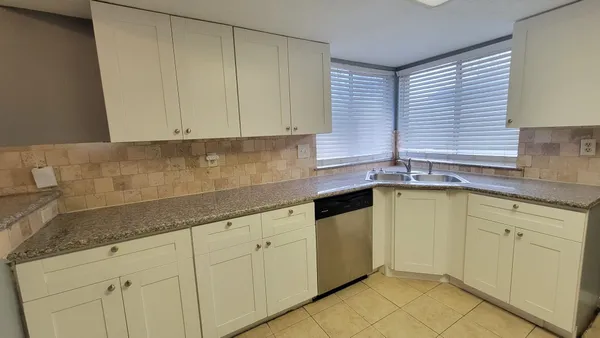 a kitchen with a sink and cabinets