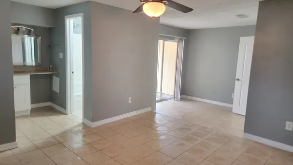 an empty room with closet and windows