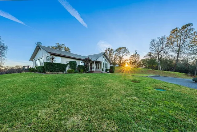 a front view of house with yard and green space