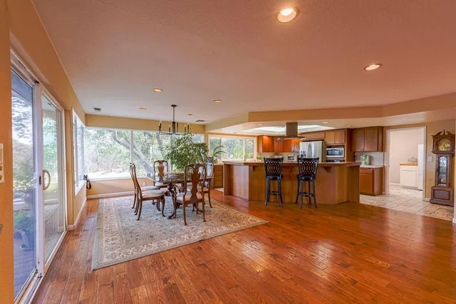 a view of a dining room with furniture and wooden floor
