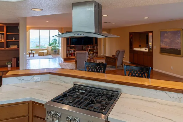 a kitchen with stainless steel appliances granite countertop a refrigerator and a sink