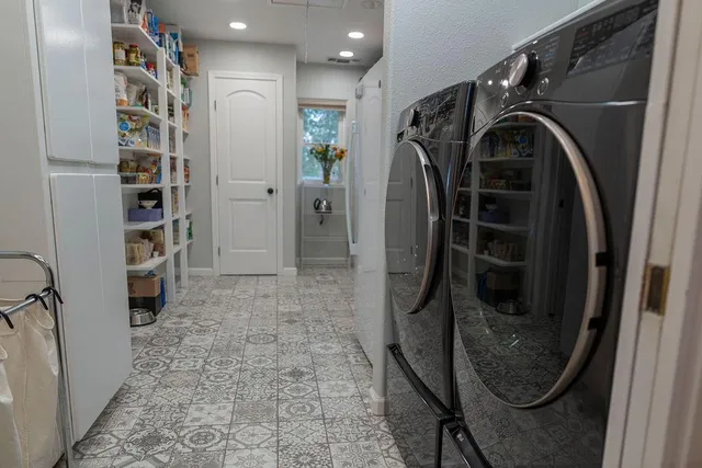 a bathroom with double vanity sinks and a mirror