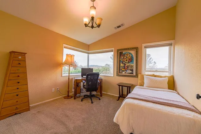 a view of a window with a vase of flower sitting next to a window