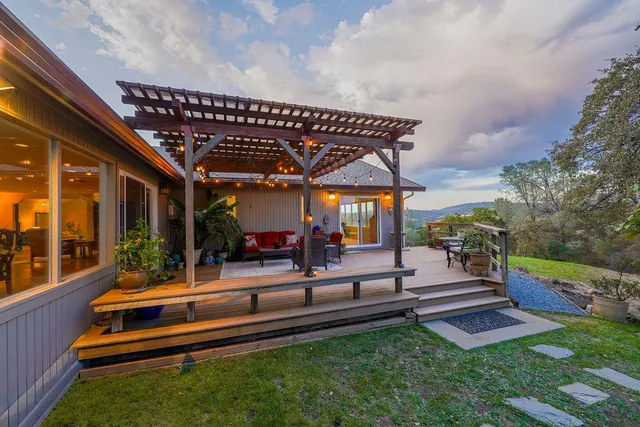 a view of a lake with beach and large trees