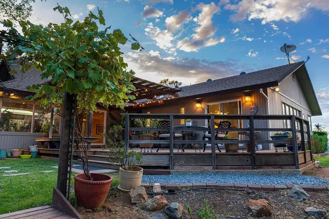 a view of a grassy field with trees in the background