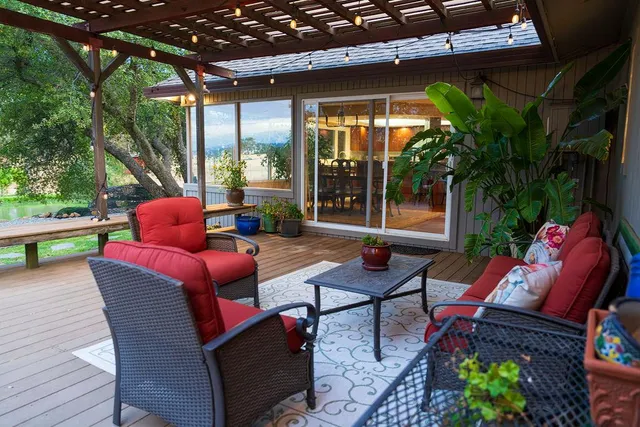 a view of a two chairs in patio of a house