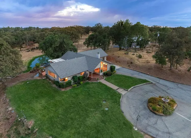 a view of a chairs and table in the backyard