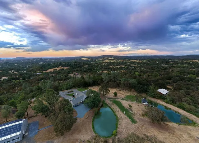 an aerial view of a house with a yard