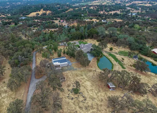 a backyard of a house with lots of green space and lake view