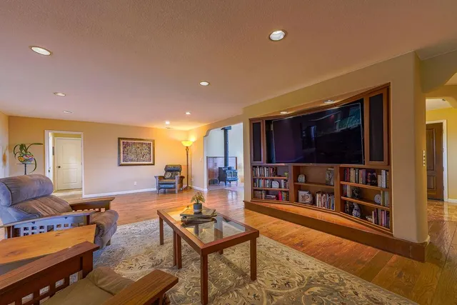 a living room with furniture and a bookshelf