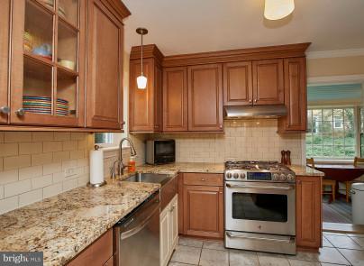 4624 19th Road North Arlington, VA 22207 - Photo 6 of 22 a kitchen with stainless steel appliances granite countertop a stove a sink and a microwave