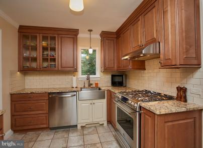 4624 19th Road North Arlington, VA 22207 - Photo 7 of 22 a kitchen with a sink stove and cabinets