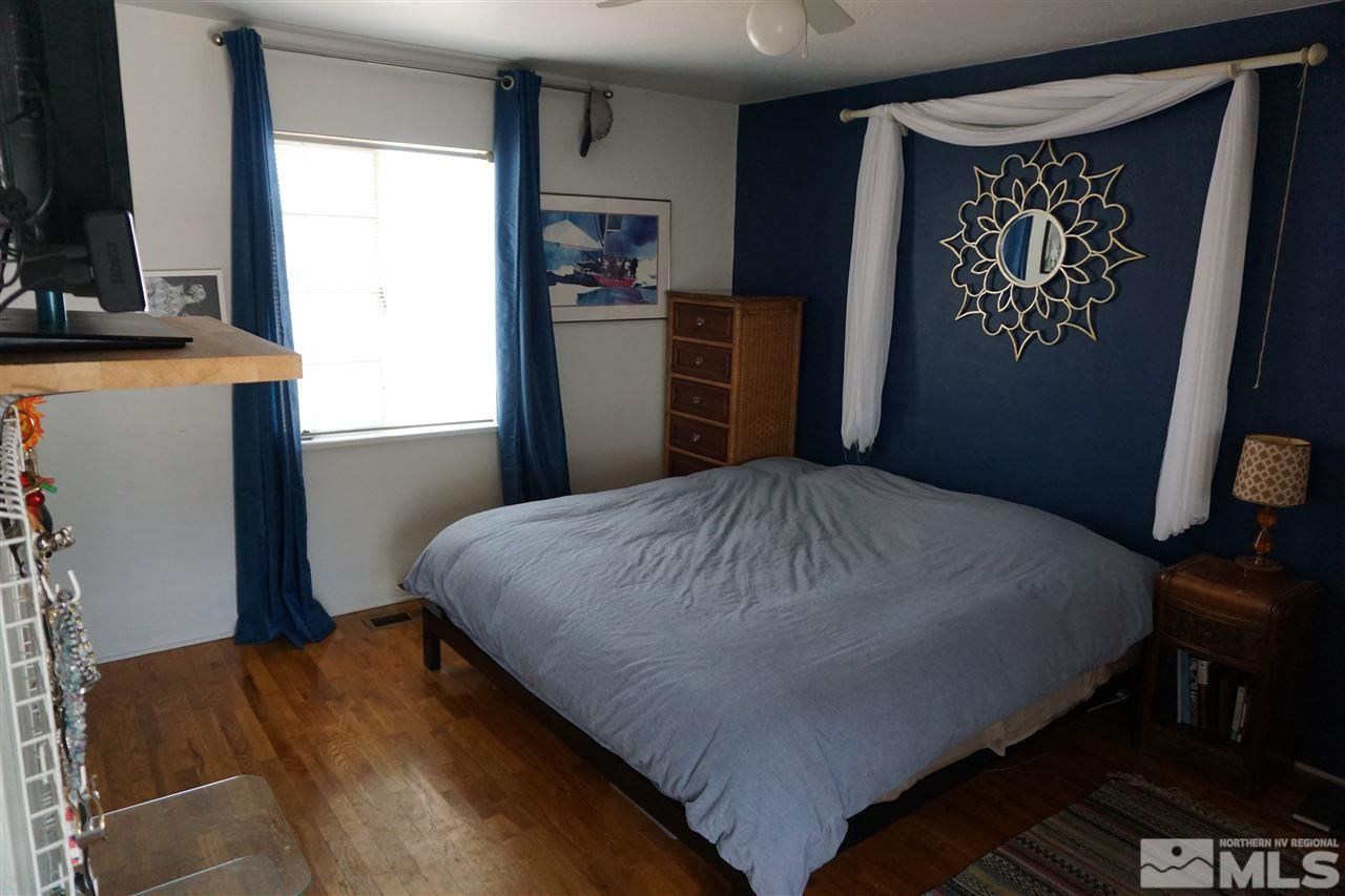845 Bates Avenue Reno, NV 89502 - Photo 14 of 18 a bedroom with a bed and a flat tv screen on dresser