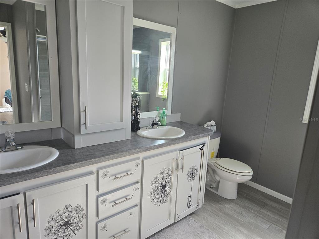 1981 Southeast Piggy Back Road Arcadia, FL 34266 - Photo 11 of 19 a bathroom with a granite countertop toilet sink and mirror