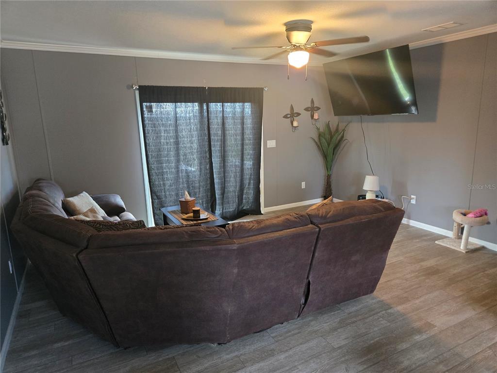 1981 Southeast Piggy Back Road Arcadia, FL 34266 - Photo 4 of 19 a living room with furniture and a chandelier