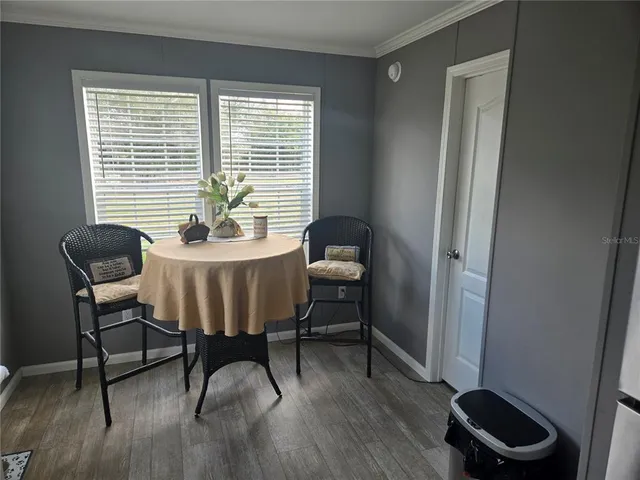 a dining room with furniture and a window