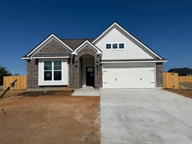a view of a house with a yard and garage