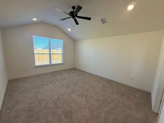 a view of a big room with a ceiling fan and a window