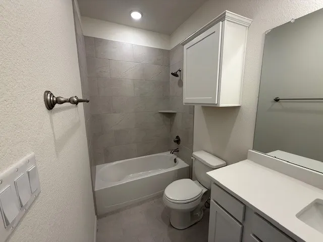 a white toilet sitting next to a bath tub