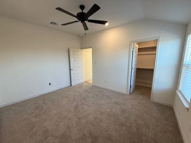 a view of a livingroom with a ceiling fan and window
